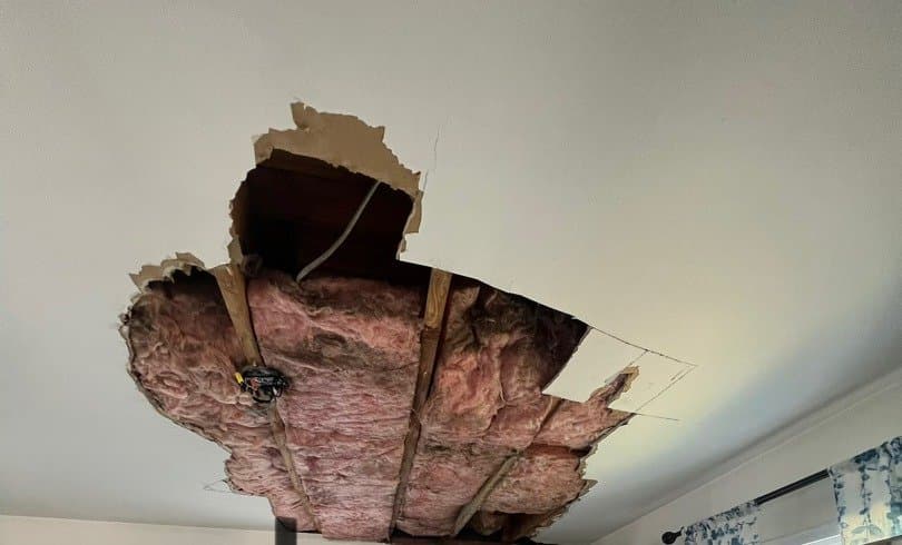 Collapsed dining room ceiling with saturated insulation hanging into the room in a Bridgeport, CT home