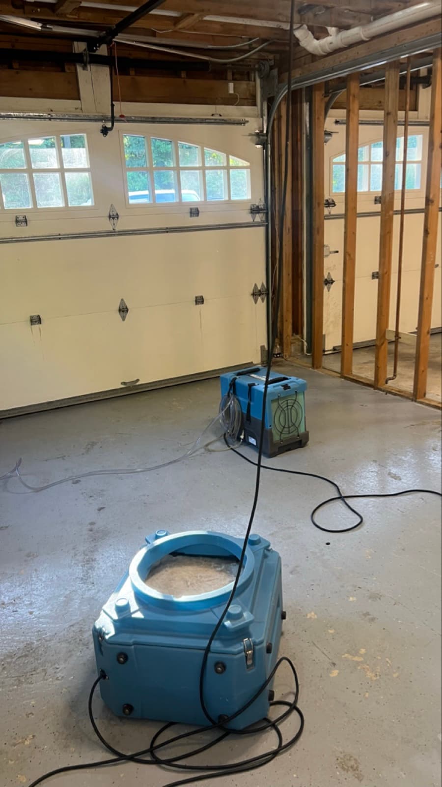 Rotted, mold-stained subfloor exposed under the master bathroom shower of a Darien, CT home before remediation