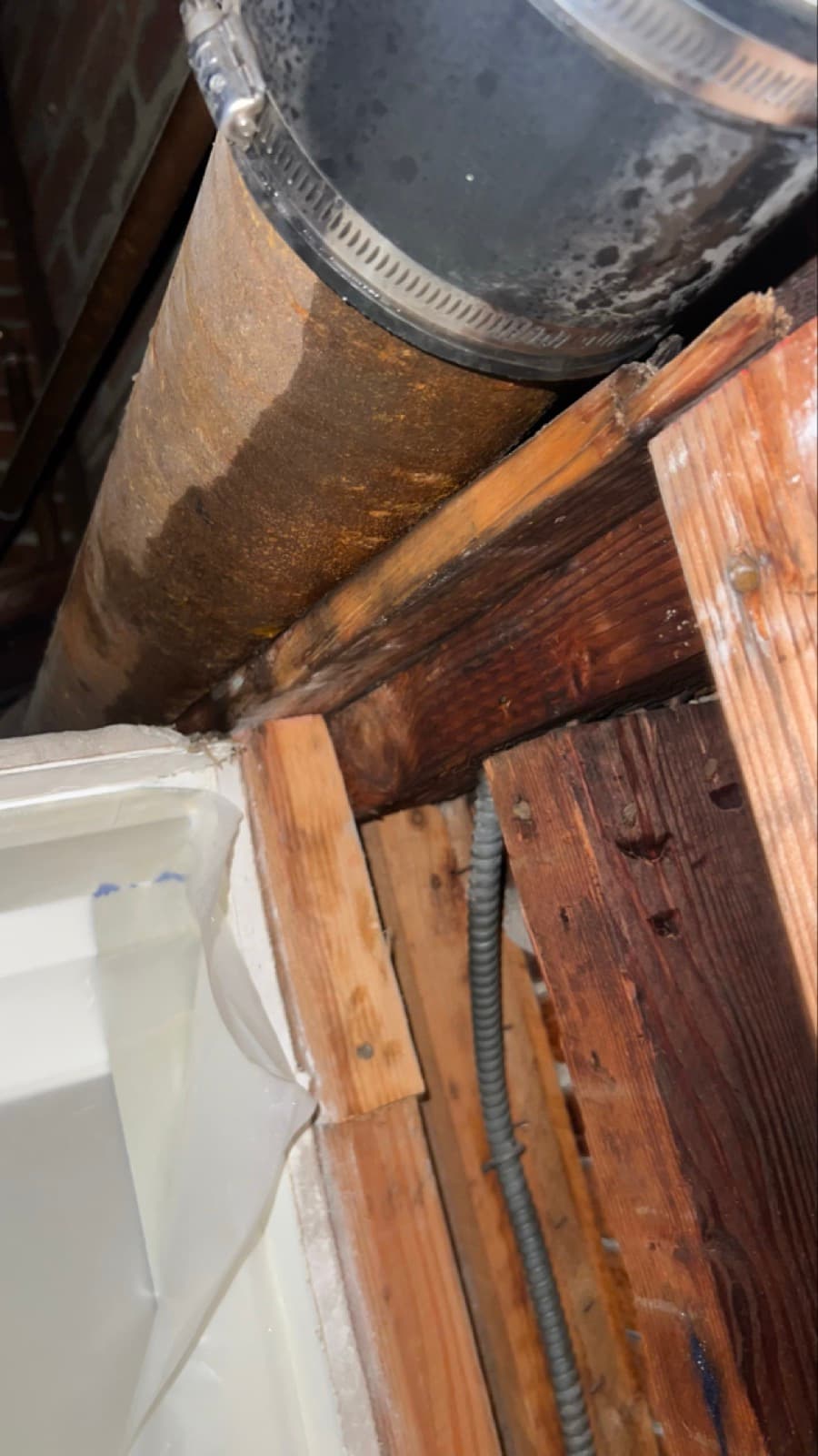 Discoloration spreading across the kitchen ceiling above the refrigerator in a Greenwich, CT home before the ceiling was opened