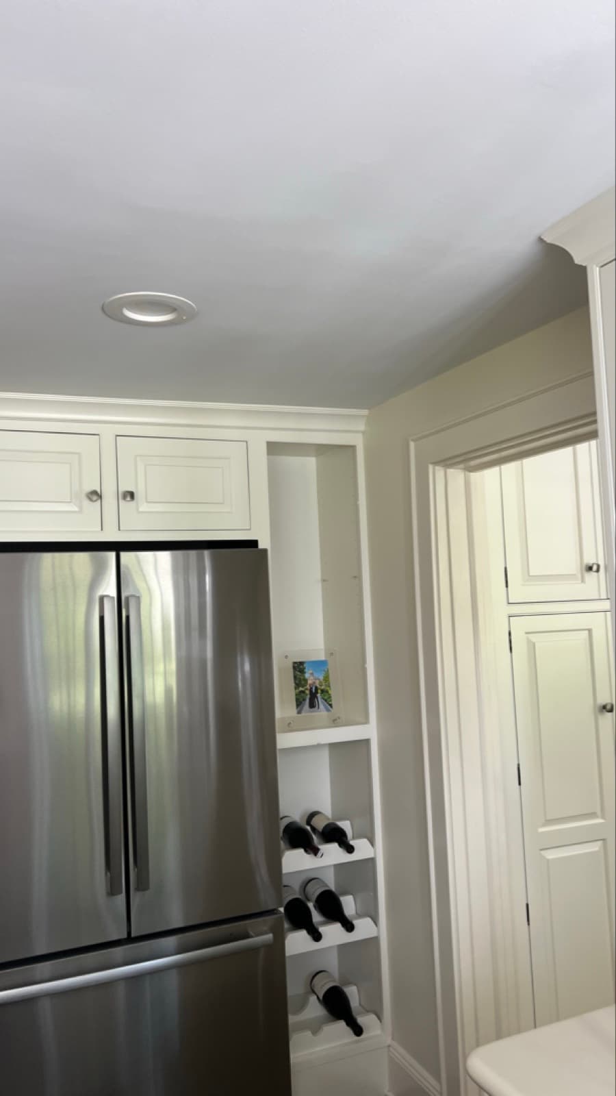 Discoloration spreading across the kitchen ceiling above the refrigerator in a Greenwich, CT home before the ceiling was opened