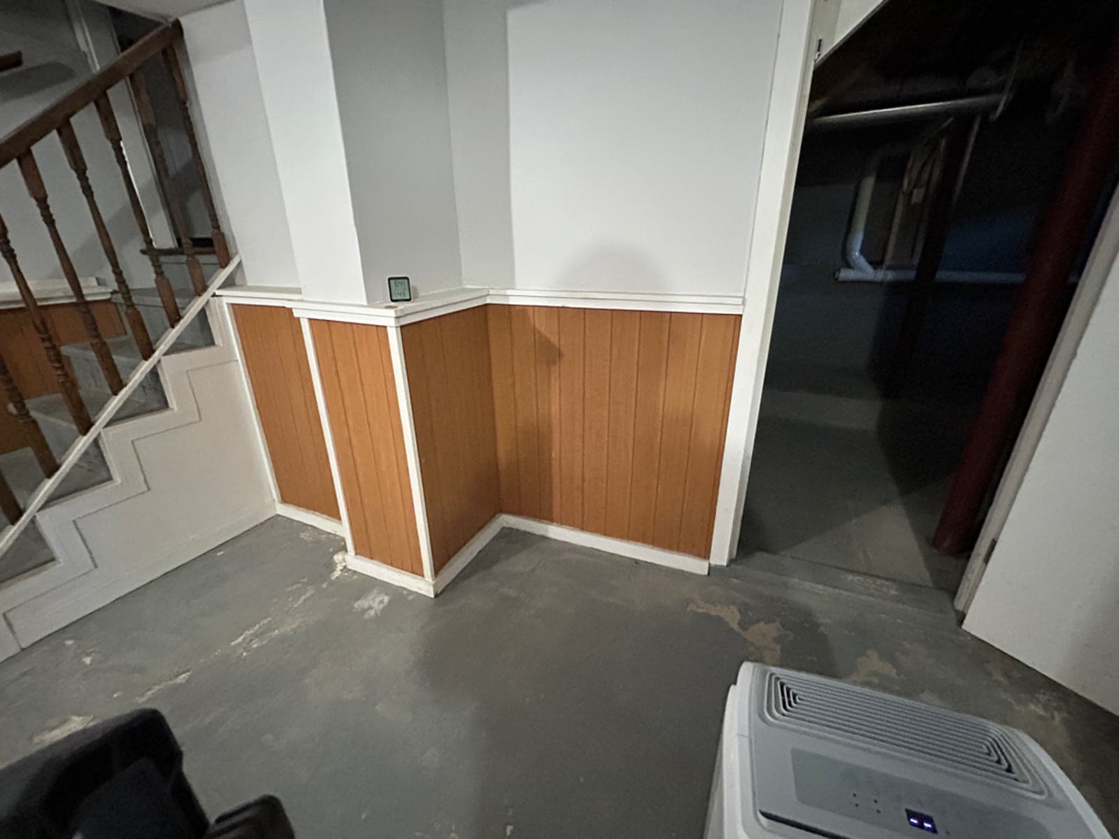 Wood panelled basement wall in a Milford, CT home before paneling removal