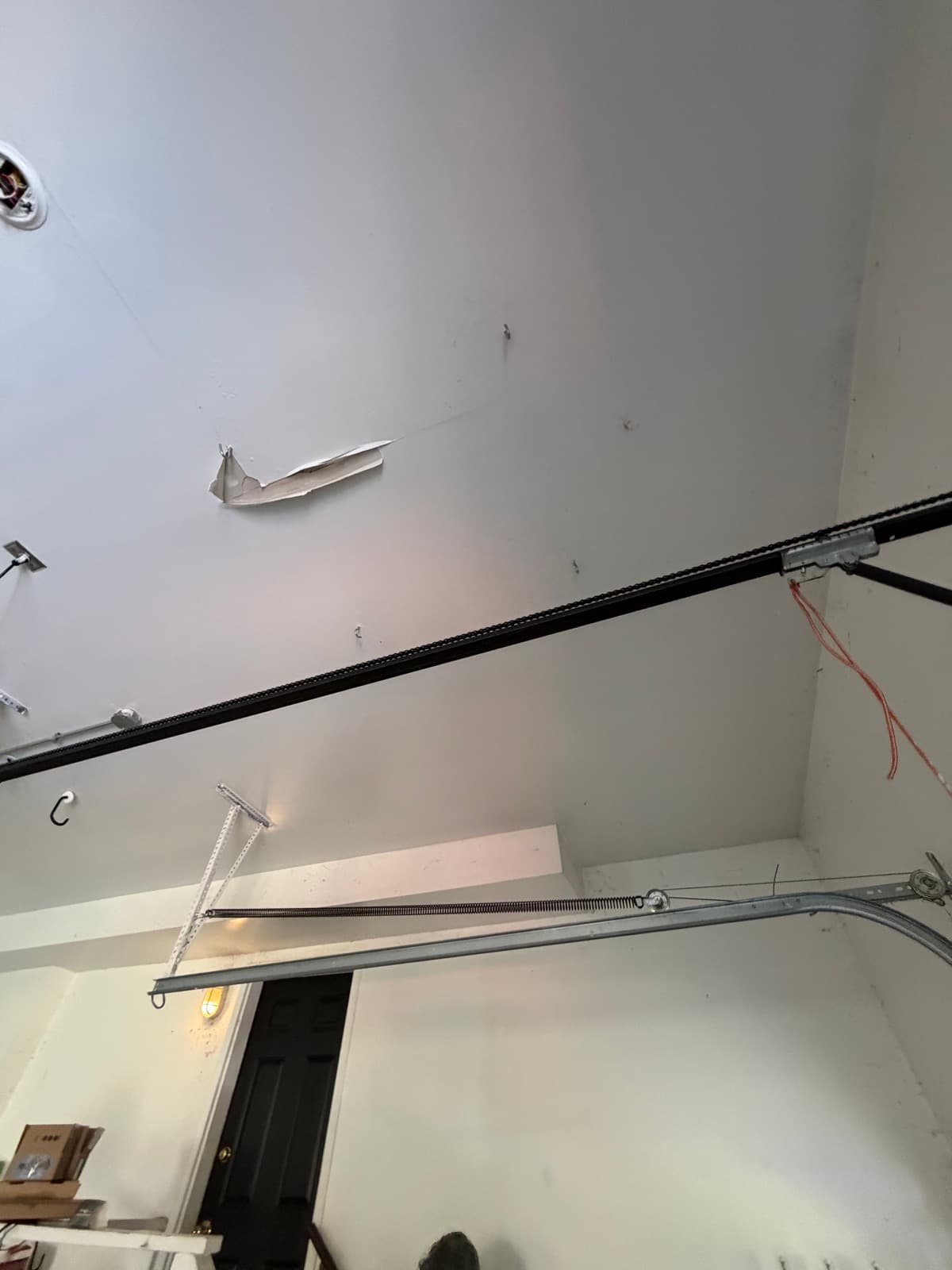 Water damaged drywall peeling away from the garage ceiling of a South Hadley, MA home