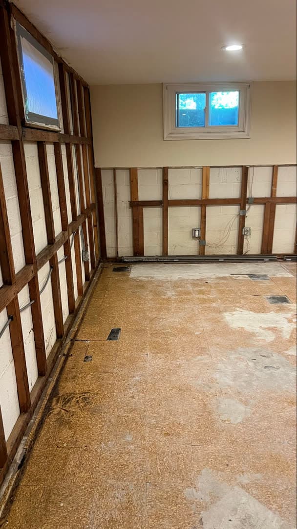 Dark mold growth along the bottom of a closet wall in a finished basement in Weston, CT