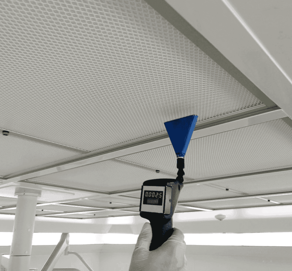 Air sampling cassette mounted on a tripod during an indoor air quality test in a home