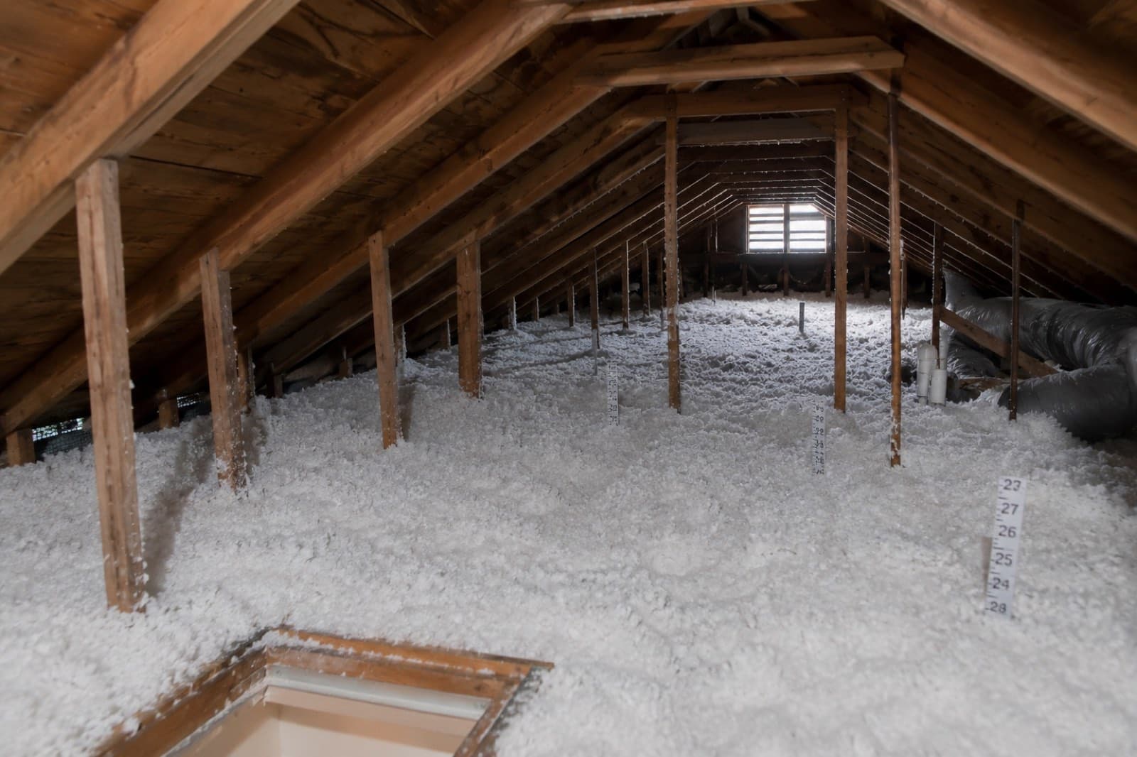 Chicopee MA attic with clean joist bays filled to an even blown-in depth after a Green Restoration insulation replacement