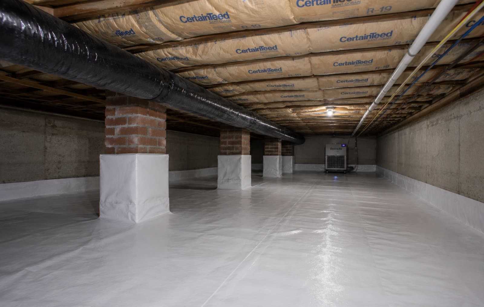 Fully encapsulated Longmeadow MA crawl space with sealed vapor barrier, R-19 batt insulation, wrapped brick piers, and Santa Fe commercial dehumidifier