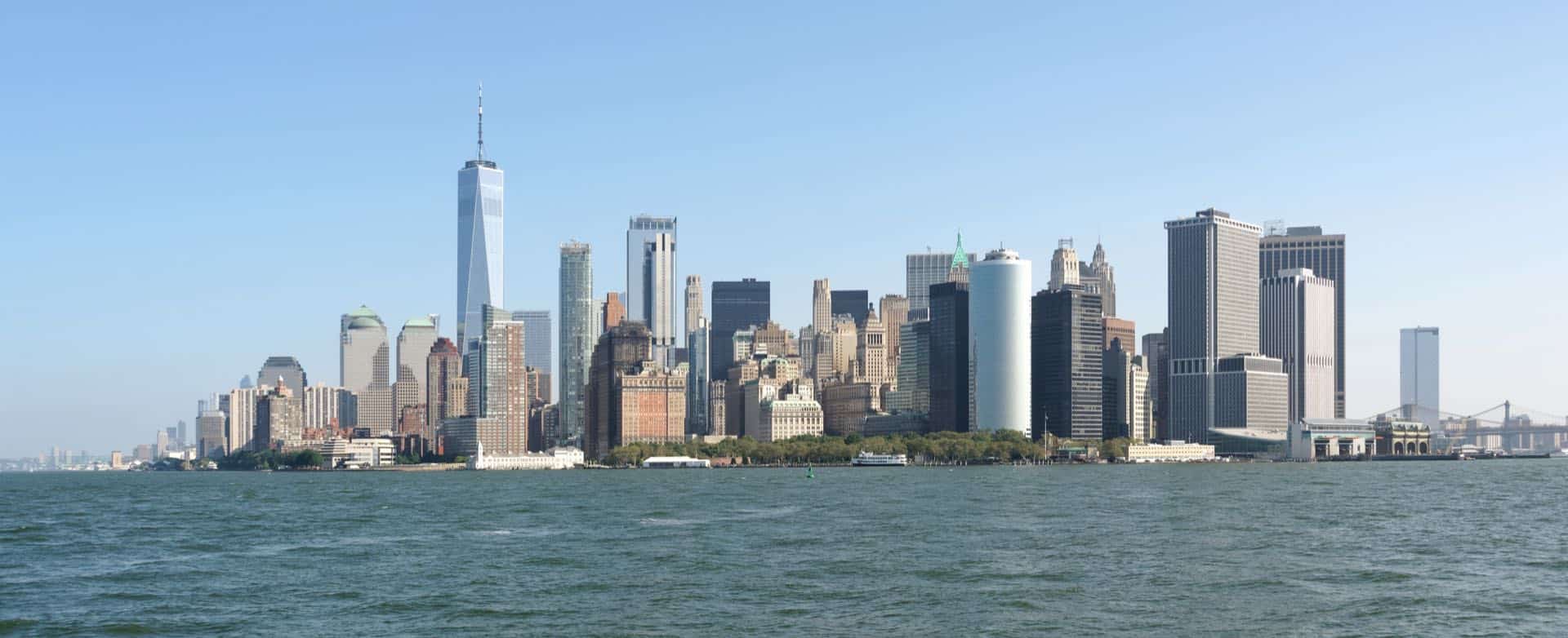 The Lower Manhattan skyline in New York City seen from Upper New York Bay. Green Restoration provides 24/7 water, fire, mold, and storm damage restoration in Manhattan, NY.