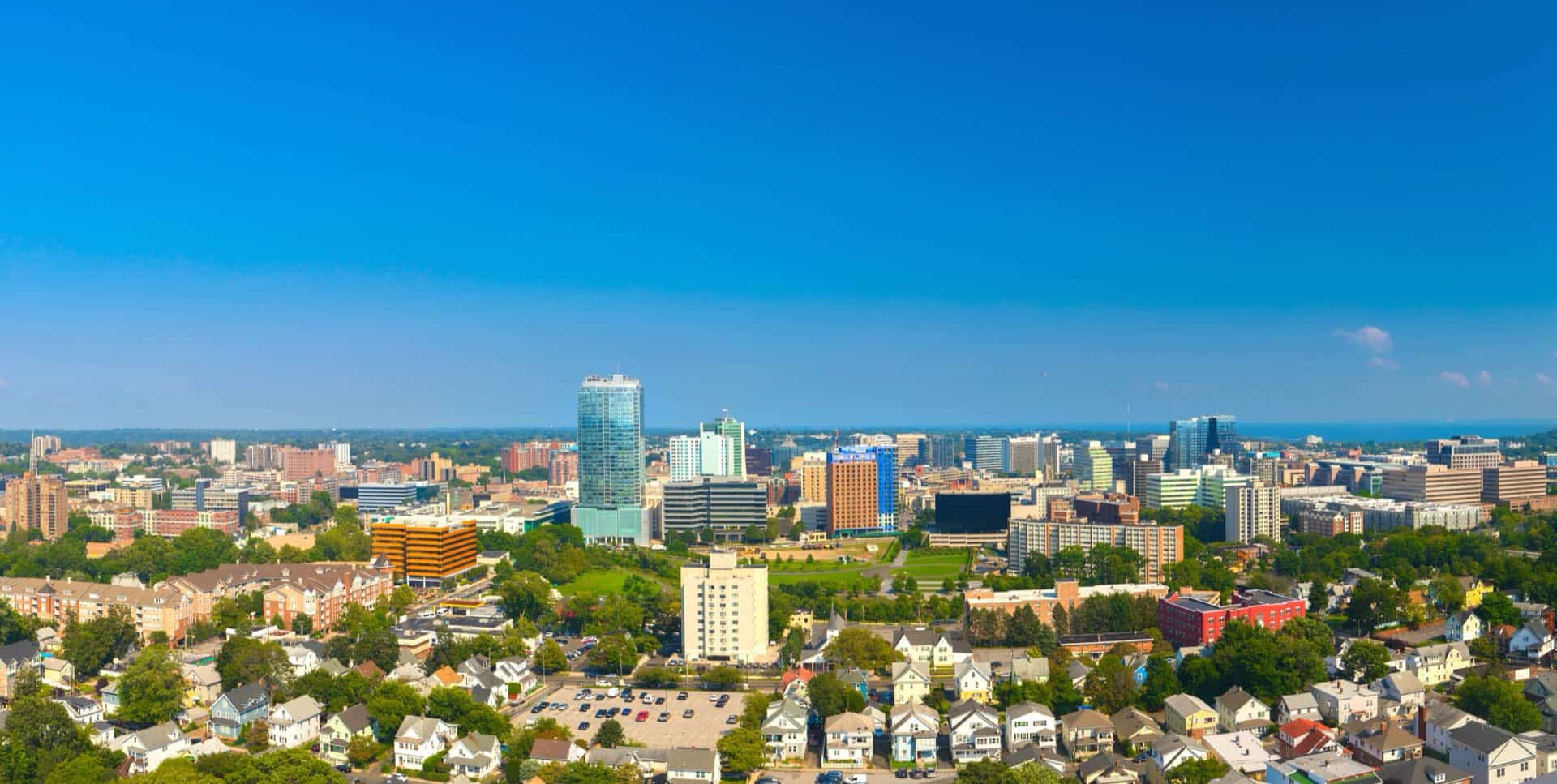 Downtown Stamford, Connecticut skyline of glass high-rise towers. Green Restoration provides 24/7 water, fire, mold, and storm damage restoration in Stamford, CT.