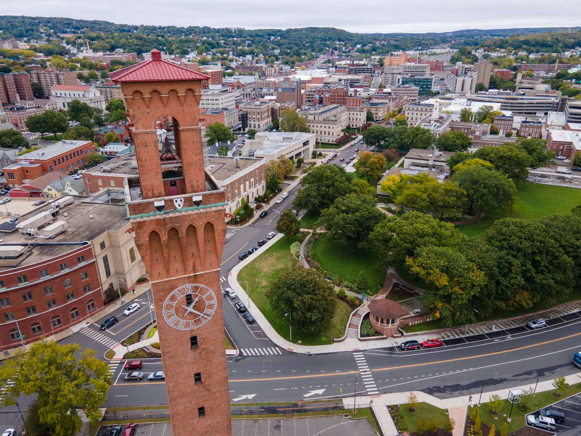 Aerial view of Waterbury, Connecticut with the Union Station clock tower and fall foliage. Green Restoration provides 24/7 water, fire, mold, and storm damage restoration in Waterbury, CT.