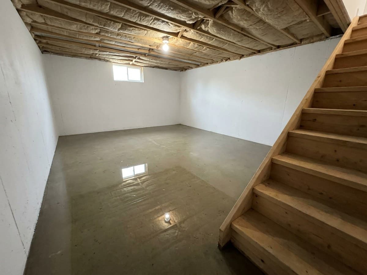 Flooded basement with standing water across the floor before extraction in a Connecticut home